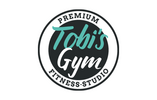 Rundes Logo von Tobi’s Gym mit schwarzem Hintergrund und türkis-weißem Schriftzug, ergänzt durch die Worte Premium Fitness Studio